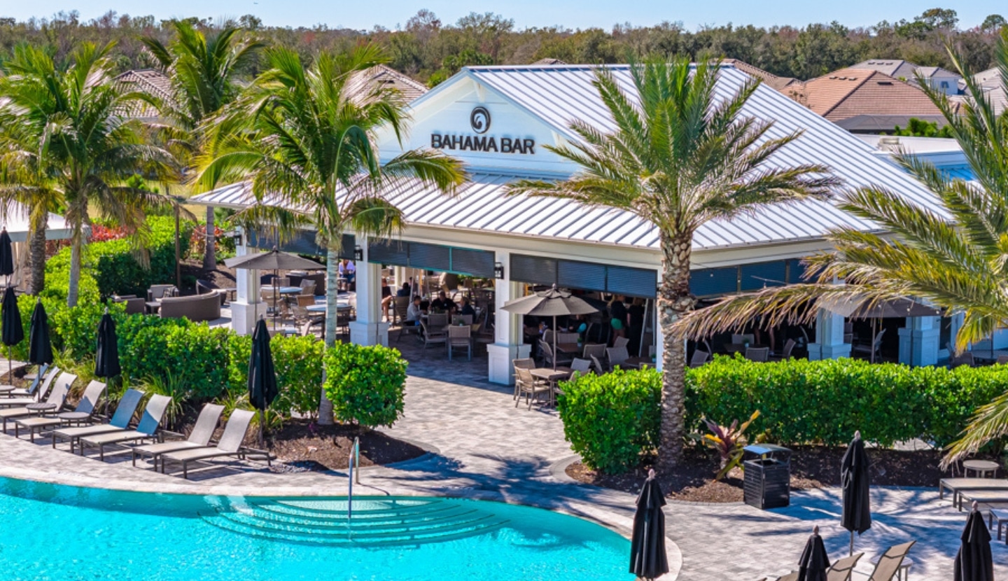 The Bahama Bar at Esplanade, an open-air pavilion beside the pool with residents gathered at its tables