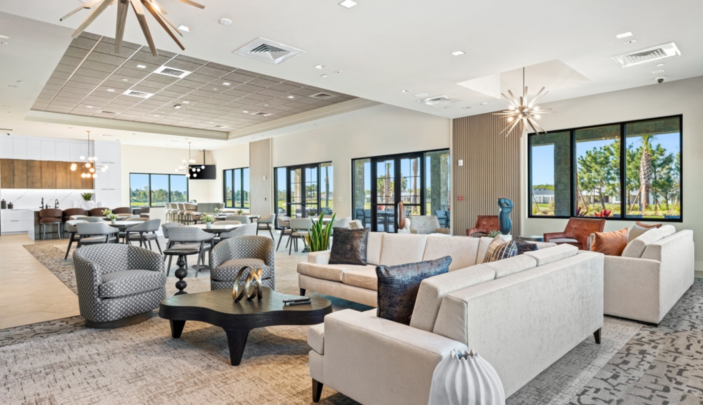 The lounge inside The Venue at Esplanade — sofas, armchairs and gathering tables beneath tall windows